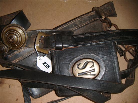 A heavy horse bridle and various farming tools